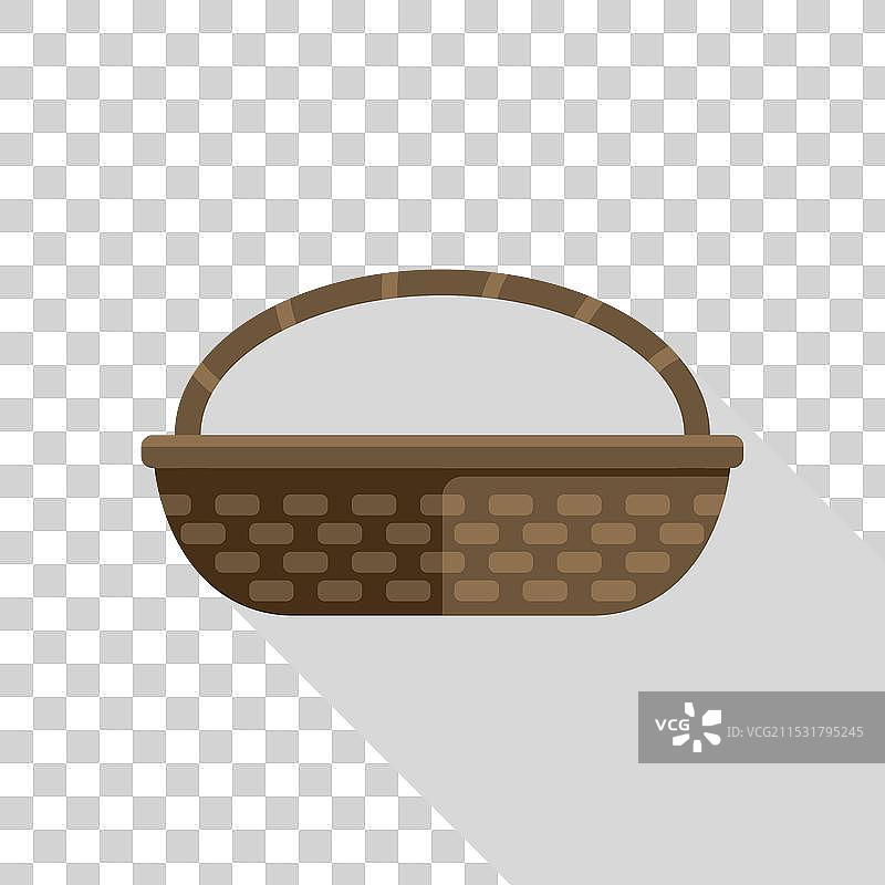 空的藤编篮子，带把手，投射出长长的影子图片素材