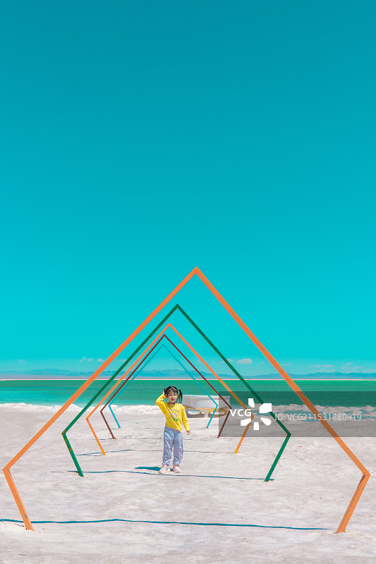 青海察尔汗盐湖雕塑下快乐的小朋友图片素材