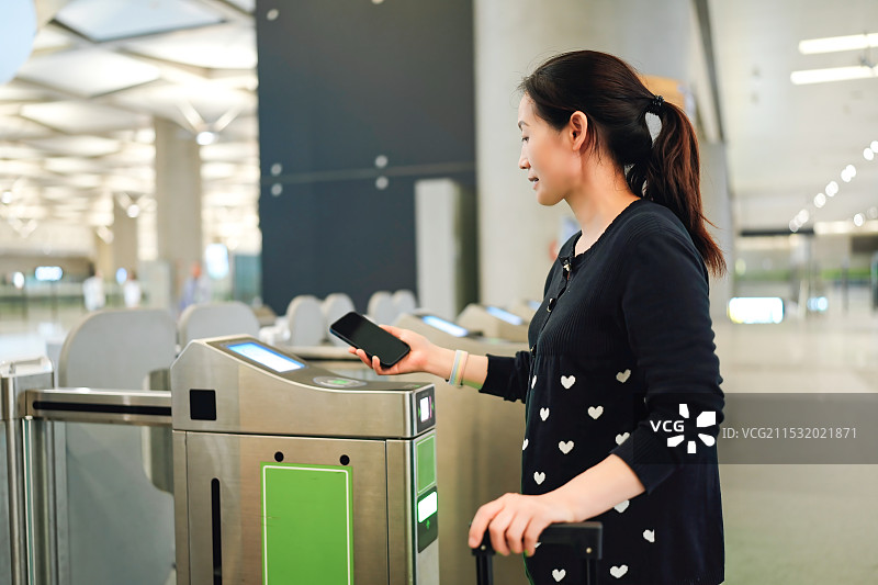 在自动检票口使用移动技术的现代通勤者图片素材