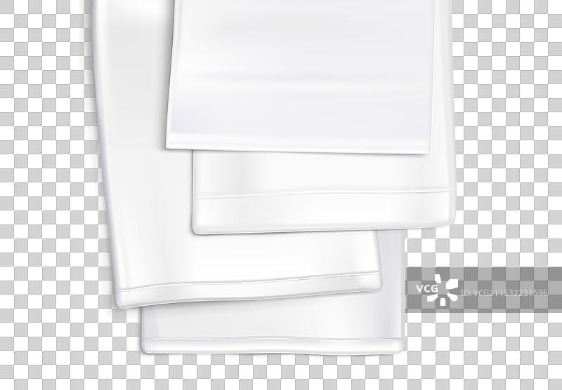 白色厨房毛巾叠放在灰色背景上图片素材