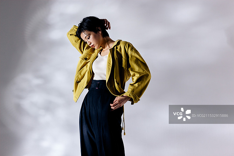 穿着黄色夹克和黑色裤子的日本女性图片素材