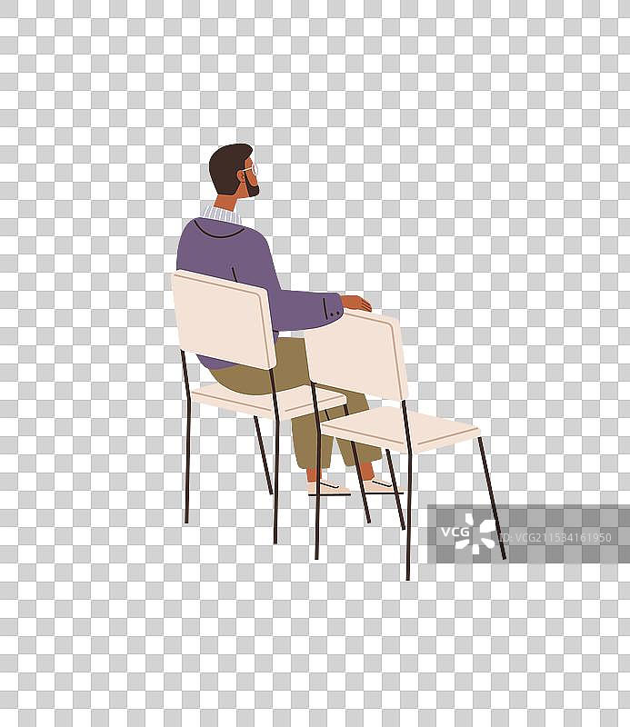 男人坐在椅子上，手势放松。图片素材