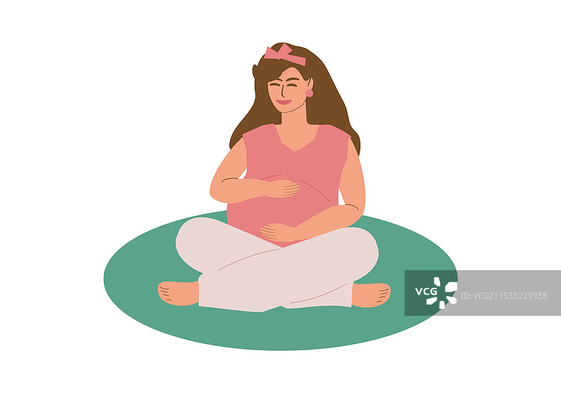 一位年轻的孕妇盘腿坐在垫子上图片素材