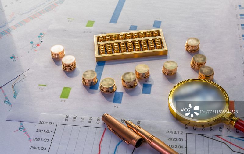 算盘、金币、放大镜、铜笔与经济数据背景图图片素材