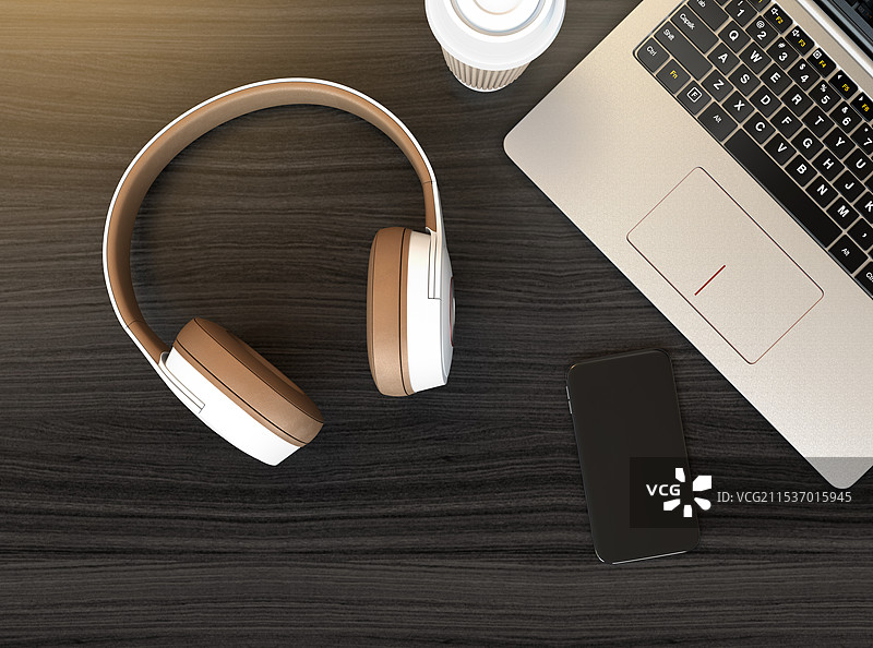 白色和浅棕色双色耳机与笔记本电脑图片素材