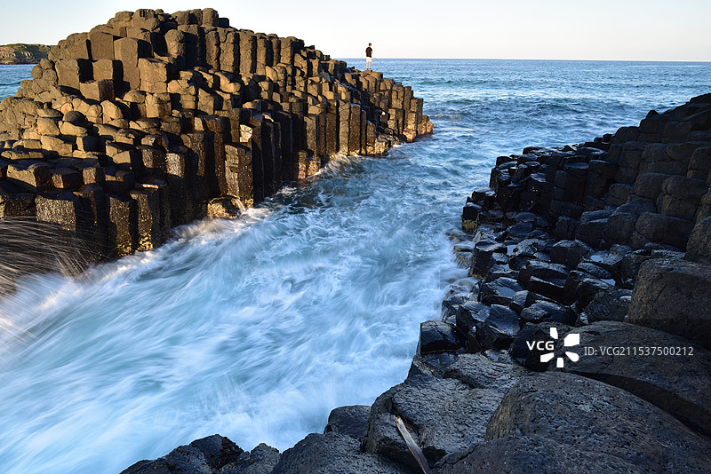 海边的岩石上有人钓鱼图片素材