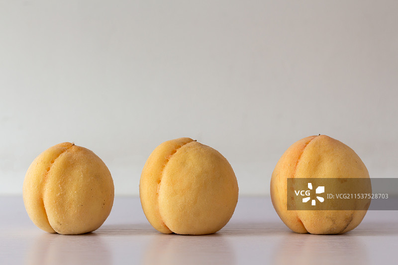 白色背景下三个桃子的特写图片素材