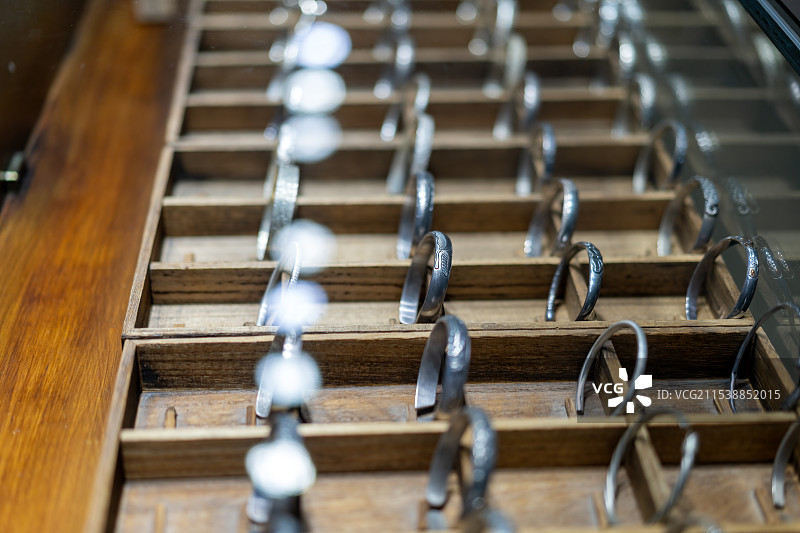 宝零售木制展示柜中的优雅银戒指图片素材