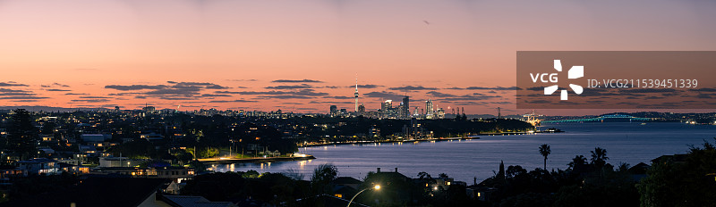 坐落在海边的新西兰的奥克兰，晚霞中的城市风光图片素材