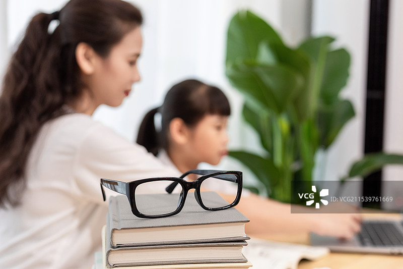 一名妈妈陪伴孩子上网课图片素材