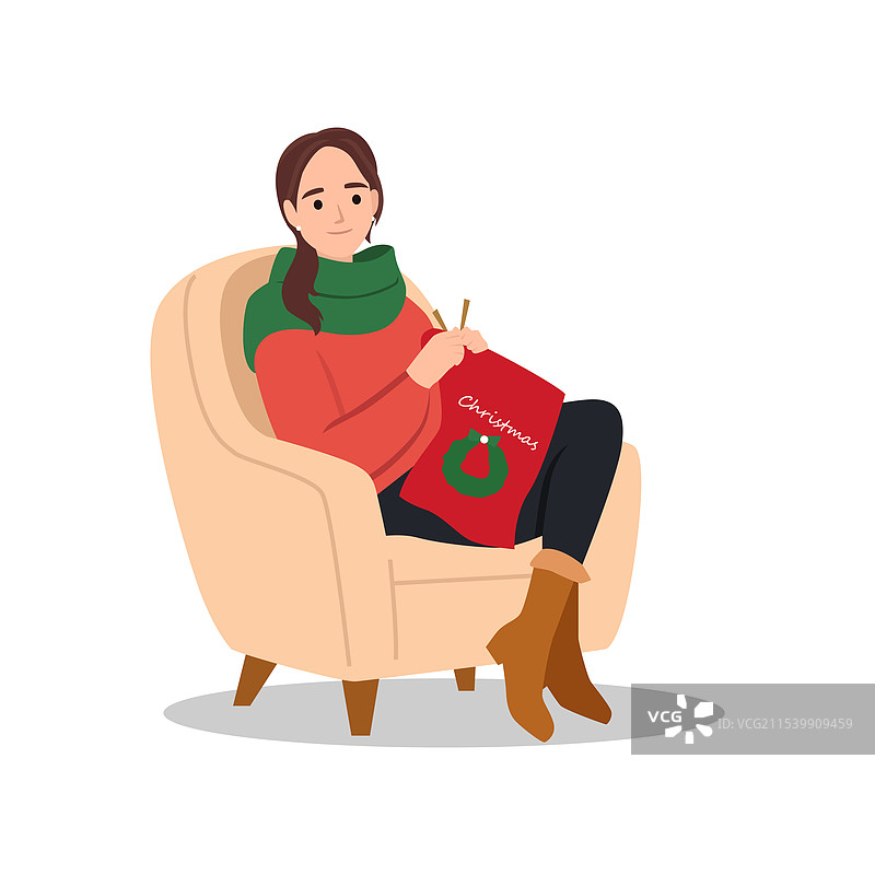 快乐的女人在编织围巾，旁边有一篮毛线图片素材