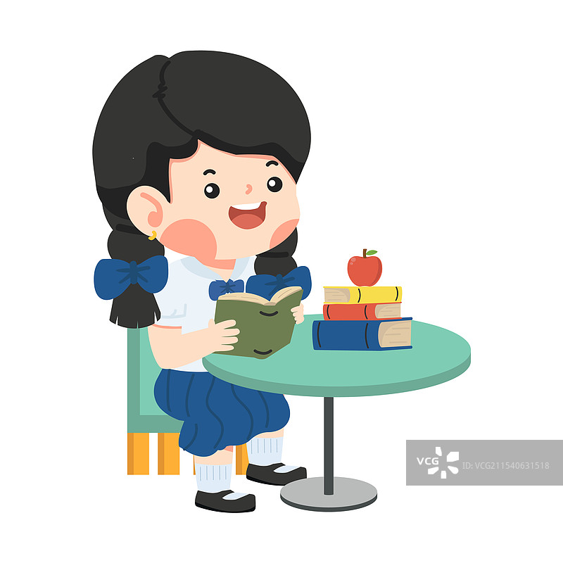 女孩坐在桌子旁阅读一本书图片素材