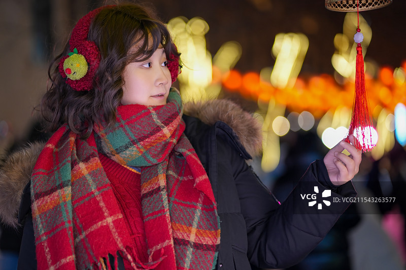 年轻女子冬季场景享受节日灯光图片素材