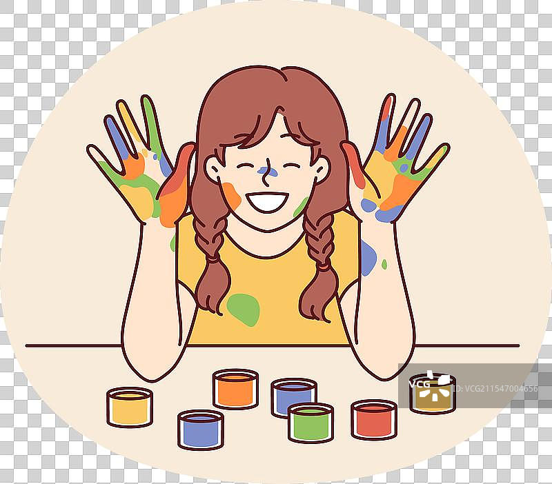 涂抹着颜料的快乐女孩，脸和手掌上满是色彩图片素材