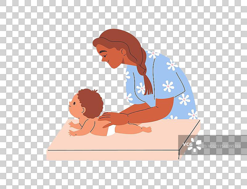 女性治疗师在换尿布台上为婴儿按摩图片素材