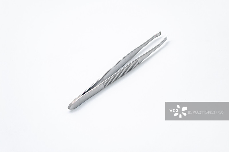 亚洲中国家庭用品拍摄主题，内室内影棚拍摄静物图像，一个不锈钢的镊子，室内无人图像摄影图片素材