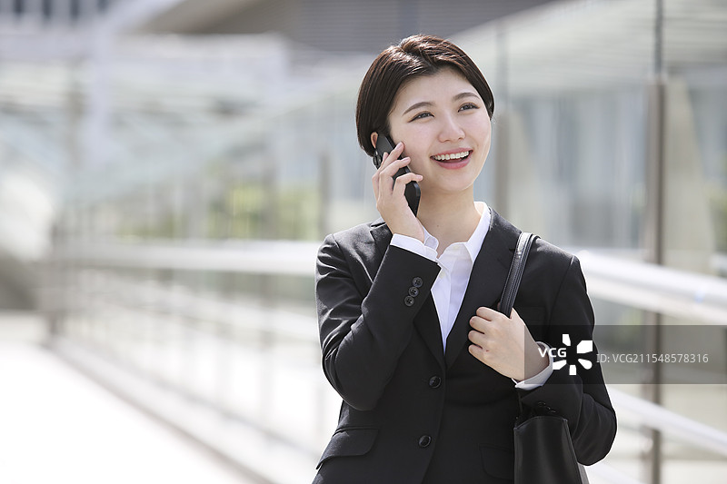 女商人正在用智能手机打电话图片素材