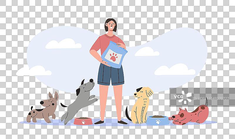 女人给狗喂食，年轻女孩手里拿着一袋食物站着。图片素材