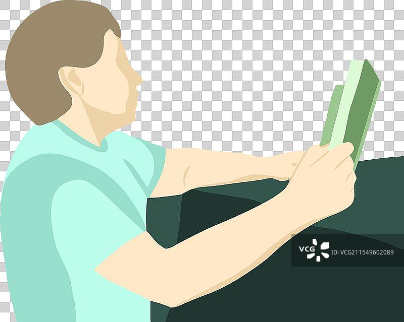 一个男人在桌子旁阅读一本书图片素材