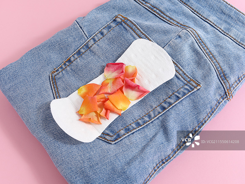 粉色背景上的裤子和女性月经用品卫生巾卫生棉图片素材