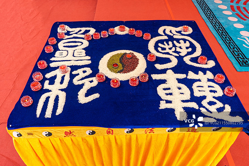 中国泰山道教九皇斋节日庆典，法坛上燃烧的蜡烛五谷杂粮做的阴阳乾坤八卦图，户外白昼无人图像摄影图片素材