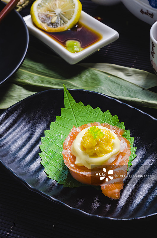 造型精美、食材丰富的日式寿司，搭配特色佐料与餐具。图片素材