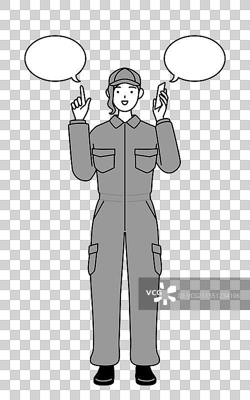 一位穿着工作服的女性机械师正在指着某个地方。图片素材