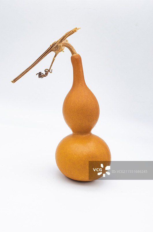 中国文玩拍摄主题，一个黄色的手捻盘玩的文玩八宝葫芦和龙头龙须，室内无人影棚拍摄图像摄影图片素材