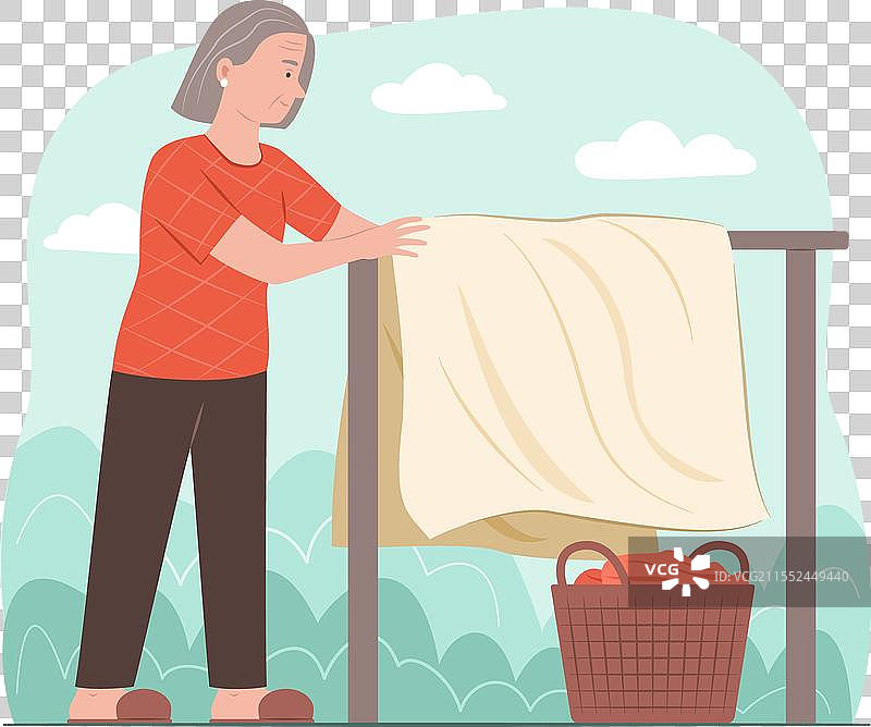 一位年长女性在晾衣绳上晾晒衣物图片素材