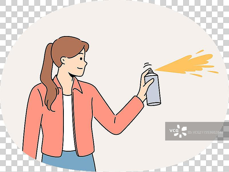 微笑的女孩在墙上喷漆图片素材