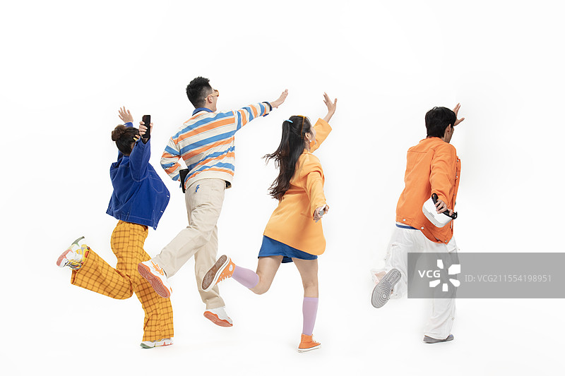 背对镜头跳跃追逐的四个年轻人图片素材