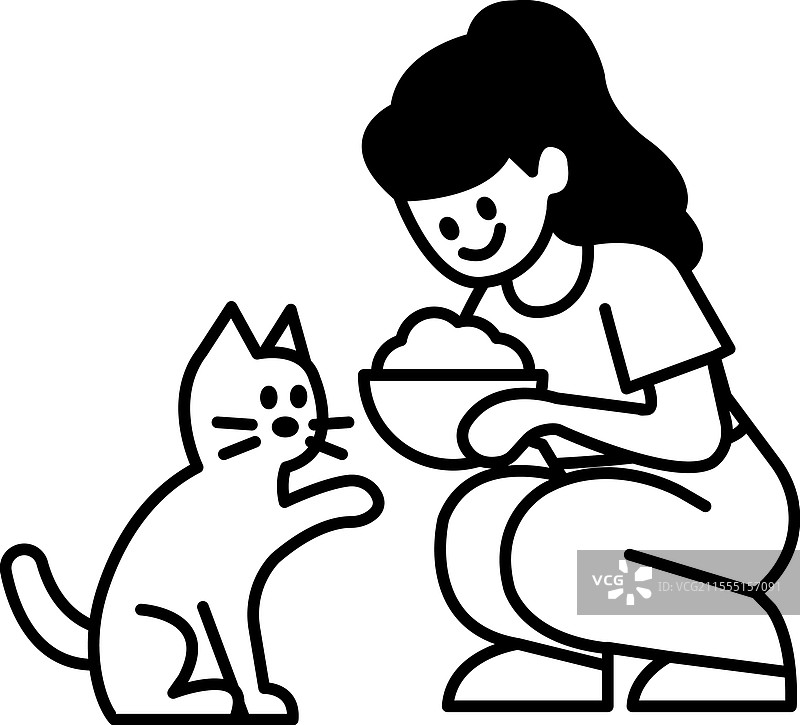 一位女性正在喂猫。图片素材