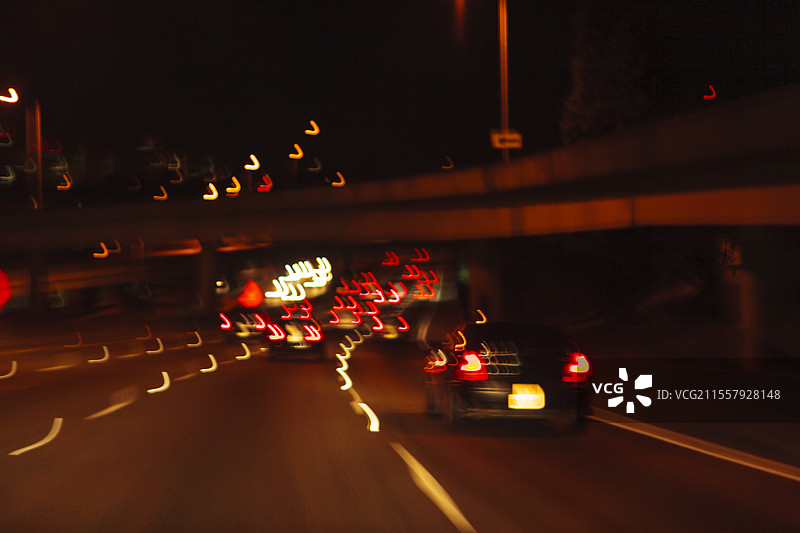 美国西雅图，模糊的驾驶视角，夜晚城市高速公路，城市的标志和街灯。图片素材