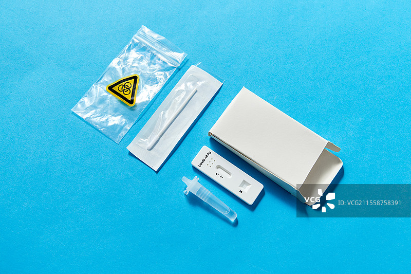 医学、自我检测和疫情概念 - 蓝色背景上的冠状病毒鼻拭子检测工具。蓝色背景上的冠状病毒鼻自测工具。图片素材