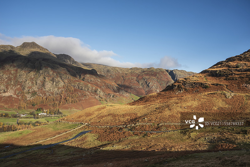 令人惊叹的秋季风景图，俯瞰皮克·奥布利斯科（Pike O'Blisco）朝向朗代尔山脊（Langdale Pikes）和山脉，阳光照耀在山脉和山谷上。图片素材