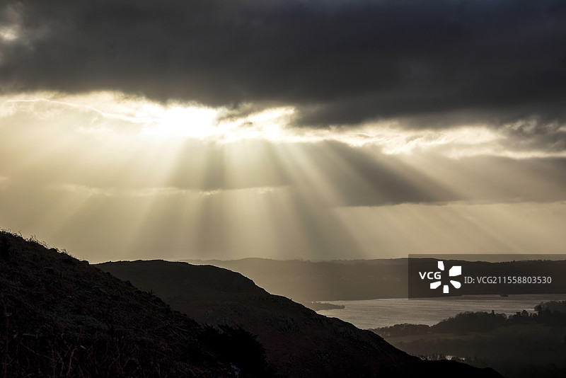 美丽的冬季日出景观，从洛赫里格山俯瞰温德米尔，壮观的阳光透过乌云洒下。图片素材