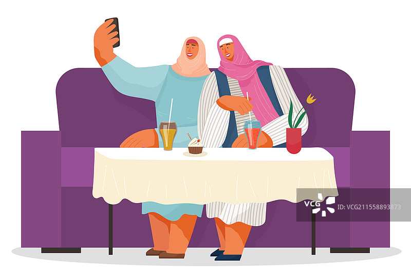 两个戴着头巾的女性朋友在一起自拍。阿拉伯女性坐在咖啡馆或餐厅的沙发上，喝着柠檬水，吃着杯子蛋糕。人们在休闲时光中度过。两个戴着头巾的女性朋友在一起自拍，阿拉伯女性坐在咖啡馆的沙发上。图片素材
