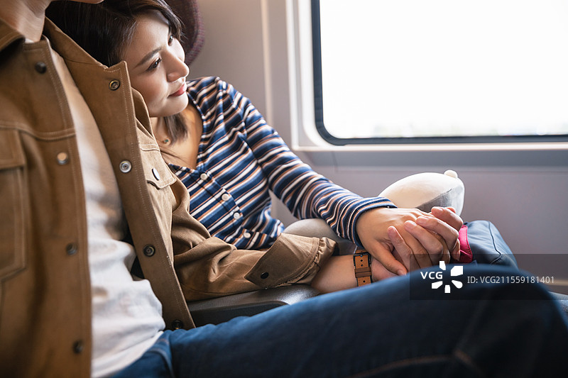 高铁车厢内坐在座位上聊天的青年情侣图片素材