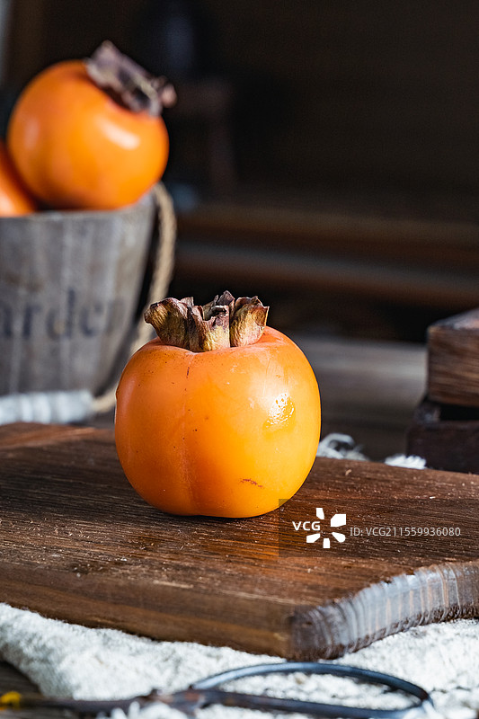 暗调静物美食自然成熟充满纹理感的柿子氛围感拍摄，让人充满食欲可做壁纸背景图片素材