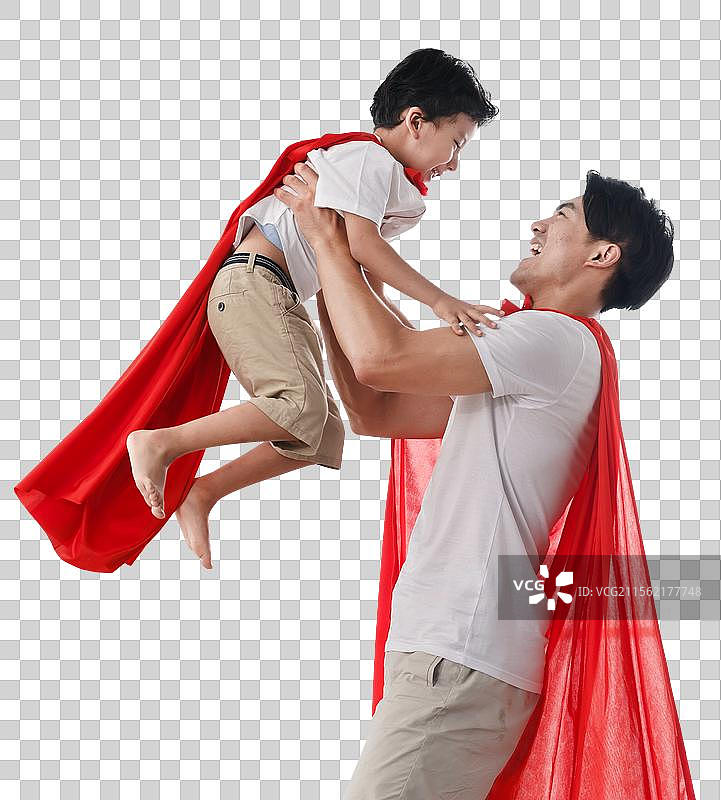 快乐的父子在扮演超人图片素材