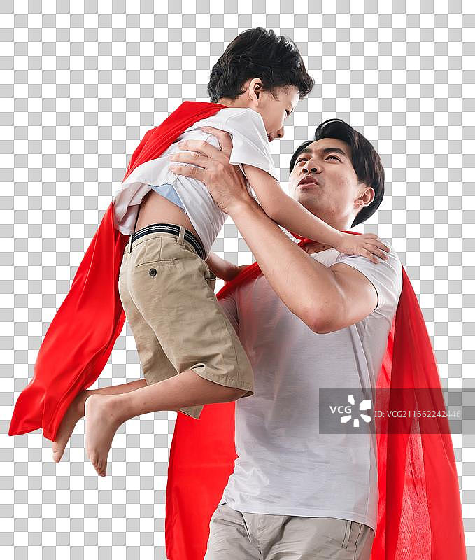 快乐的父子在扮演超人图片素材