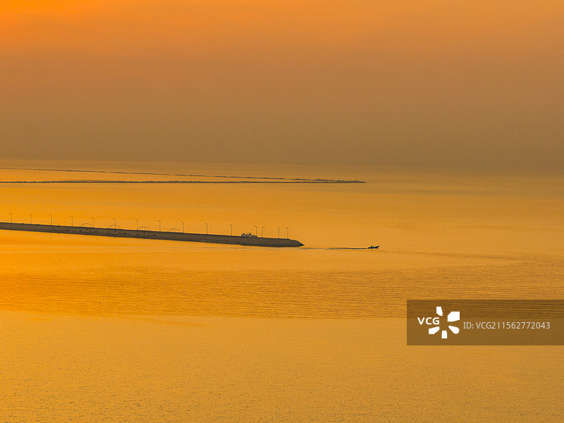营口鲅鱼圈夕阳下海边沙滩日落夕阳下的大海图片素材