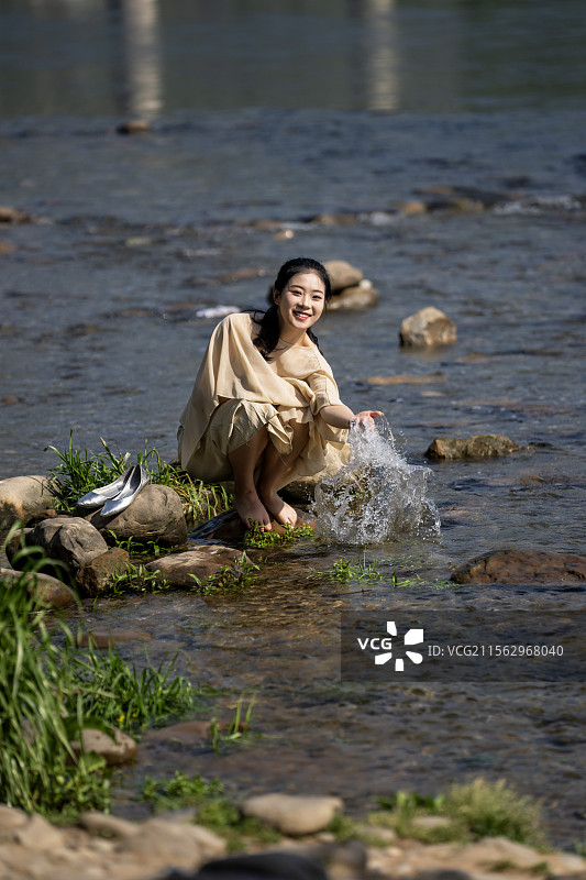 一位穿汉服的美女在湖北恩施清江河边嬉戏图片素材