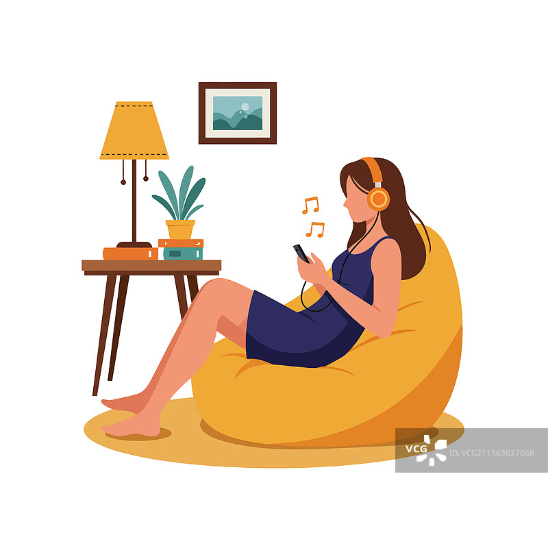女人坐在豆袋椅上放松，听着音乐图片素材
