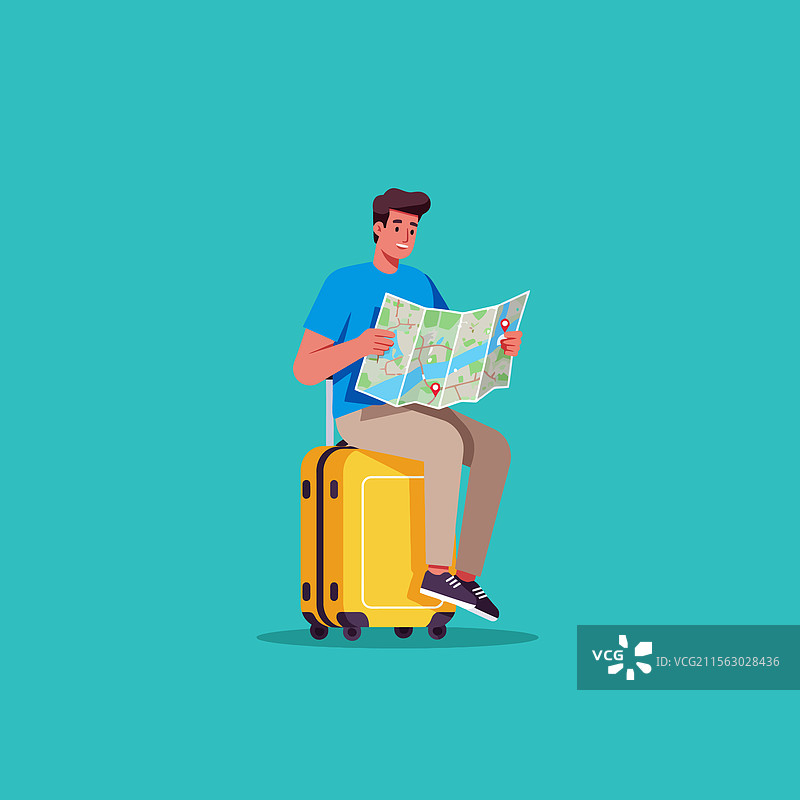 男人坐在行李箱上看地图，准备出发。图片素材