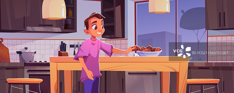 男孩在桌子上的盘子里吃巧克力饼干图片素材