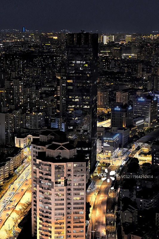 摩天大楼两旁繁忙的轻轨与高架道路 Urban traffic at night图片素材