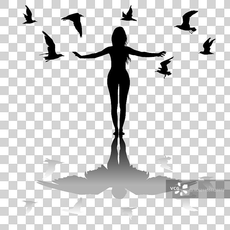 被飞翔的鸟儿环绕的女性剪影图片素材