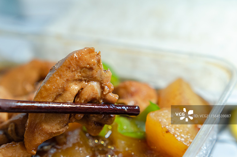 筷子夹起的美味鸡肉菜肴特写图片素材