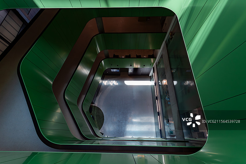 光影交错的绿色办公空间：俯拍现代大楼室内的宁静与活力图片素材